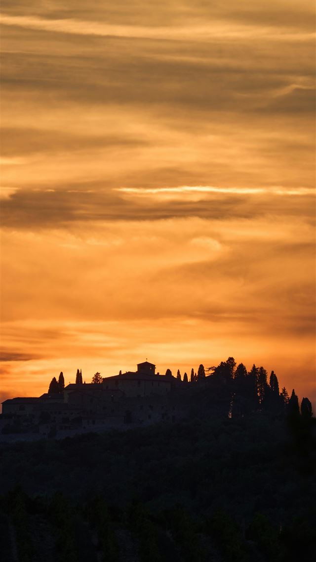 1290x2796 The sun is setting over a small hill -  iPhone Wallpaper