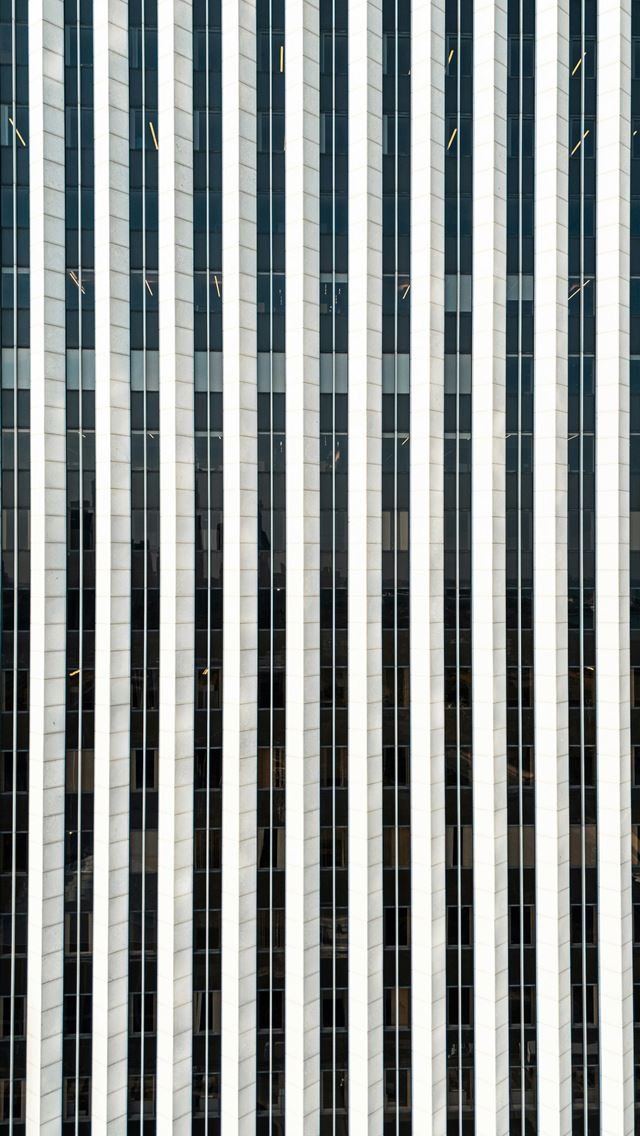 1290x2796 A tall building with many vertical lines on it -  iPhone Wallpaper