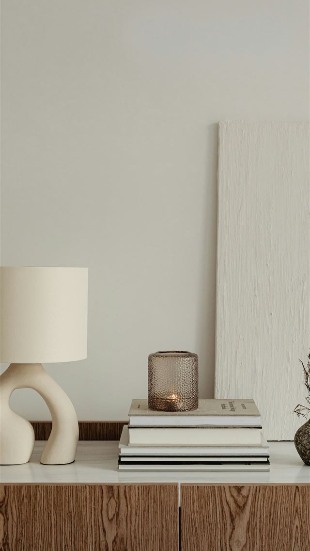 1290x2796 a lamp and books on a table -  iPhone Wallpaper
