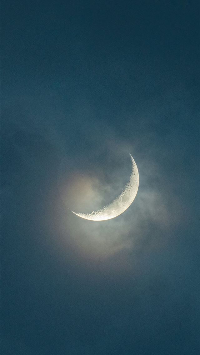 1290x2796 a crescent moon is seen through the clouds -  iPhone Wallpaper