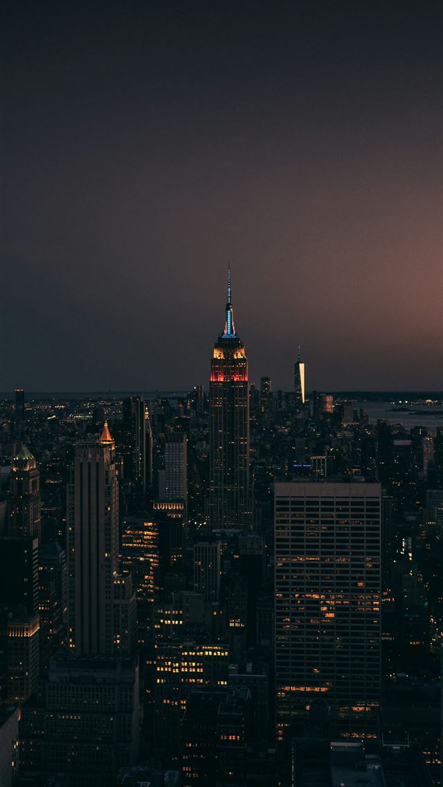 1290x2796 a view of a city at night from the top of a buildi... -  iPhone Wallpaper