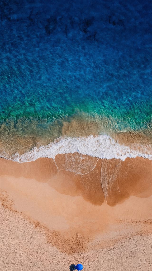1290x2796 Ocean waves wash onto a sandy beach  -  iPhone Wallpaper