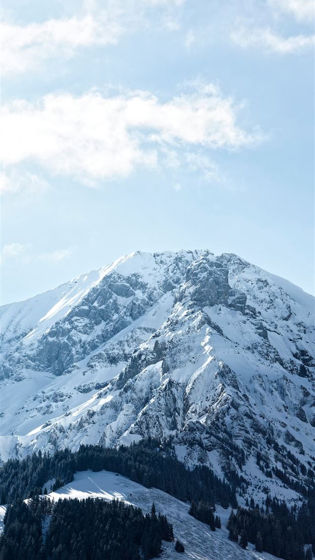 1290x2796 a mountain covered in snow under a cloudy blue sky -  iPhone Wallpaper