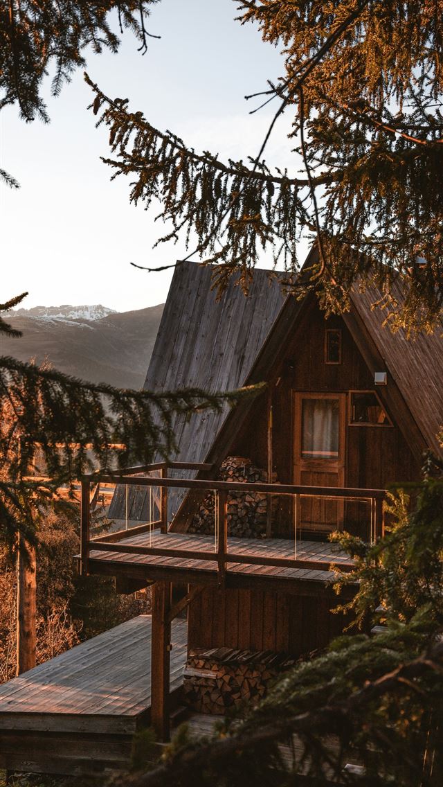 1290x2796 a wooden cabin with a porch and a deck -  iPhone Wallpaper