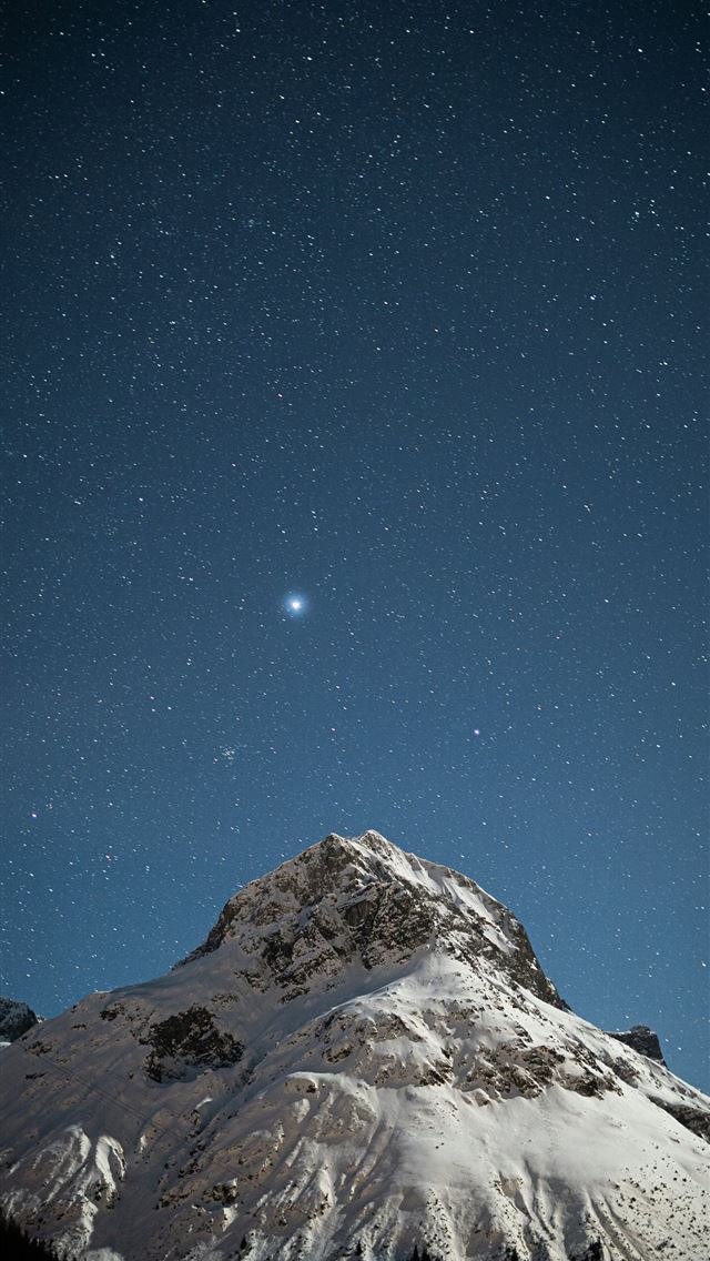 1290x2796 a snow covered mountain under a star filled sky -  iPhone Wallpaper