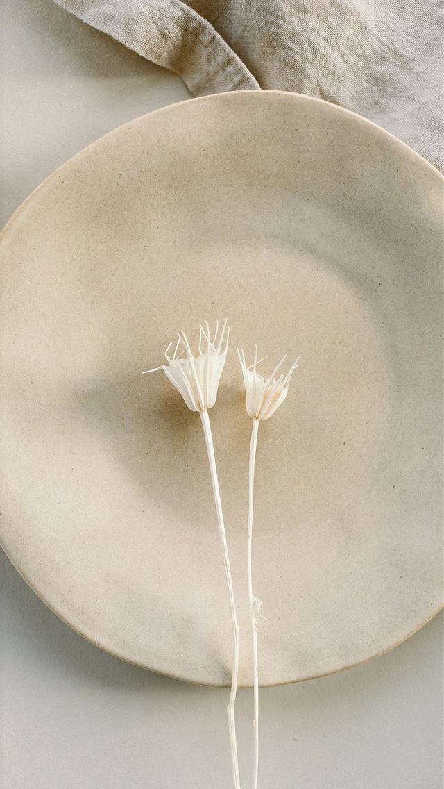 1290x2796 a white plate with two white flowers on it -  iPhone Wallpaper
