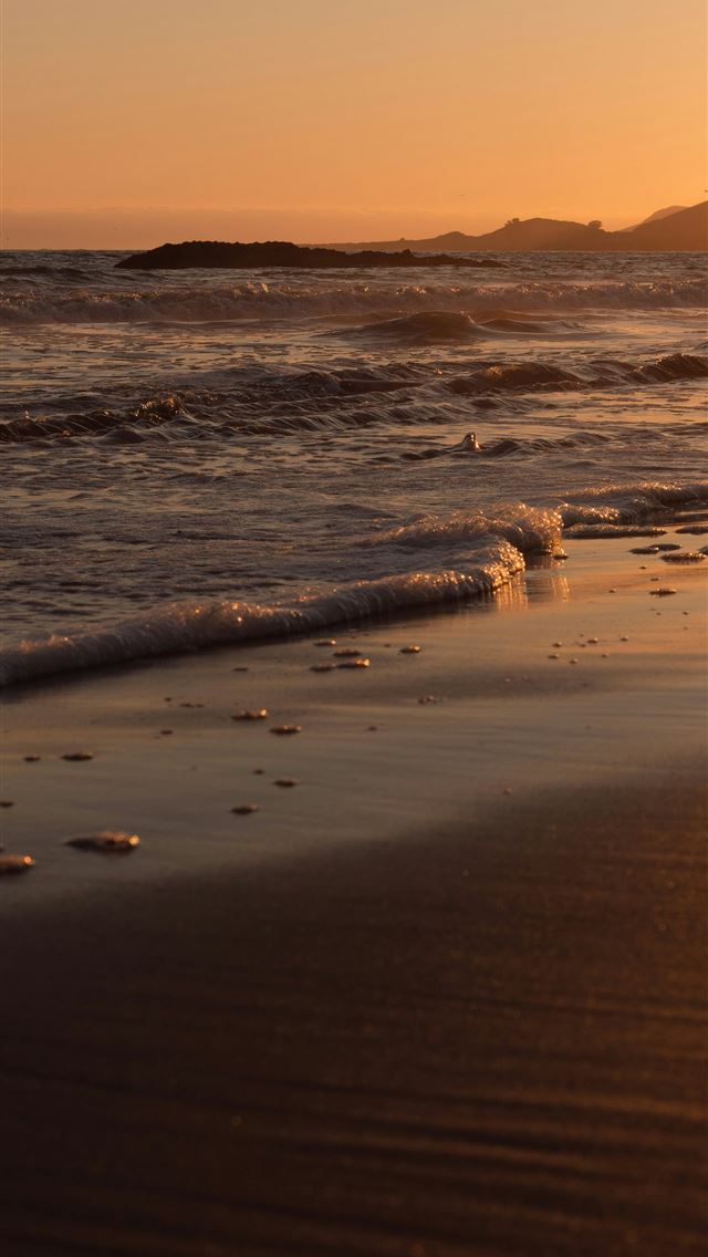 1290x2796 The sun is setting over the ocean on the beach -  iPhone Wallpaper