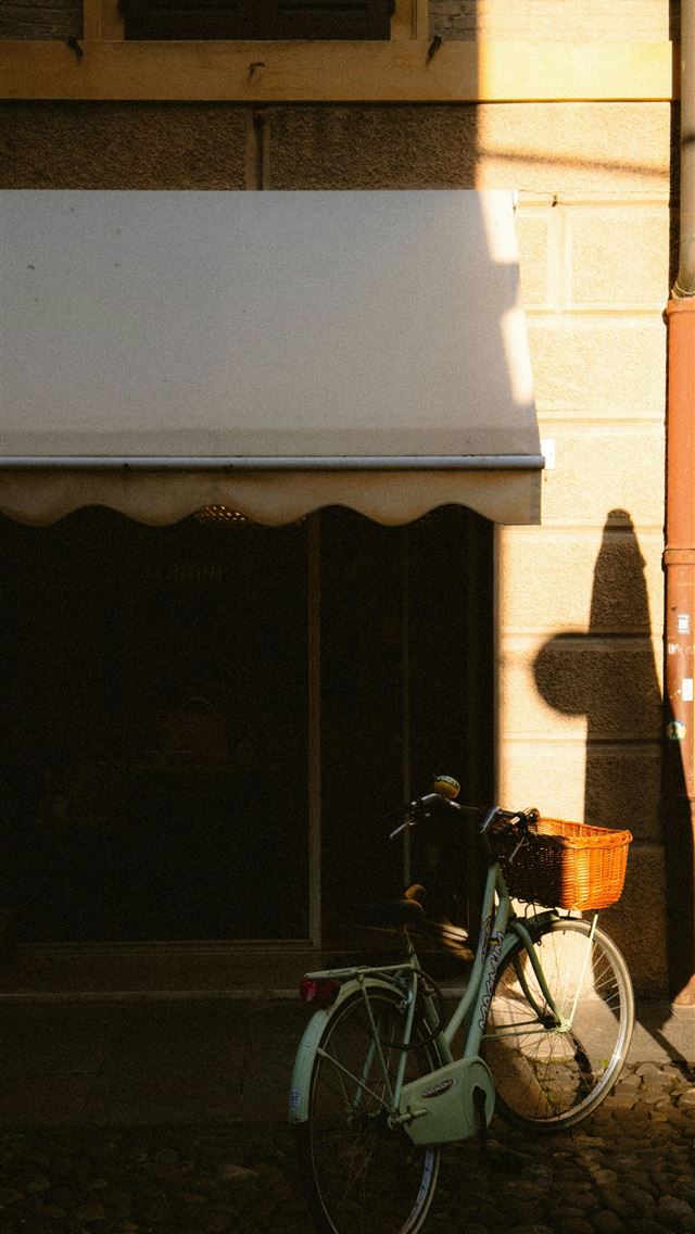 1290x2796 a bicycle parked in front of a building -  iPhone Wallpaper