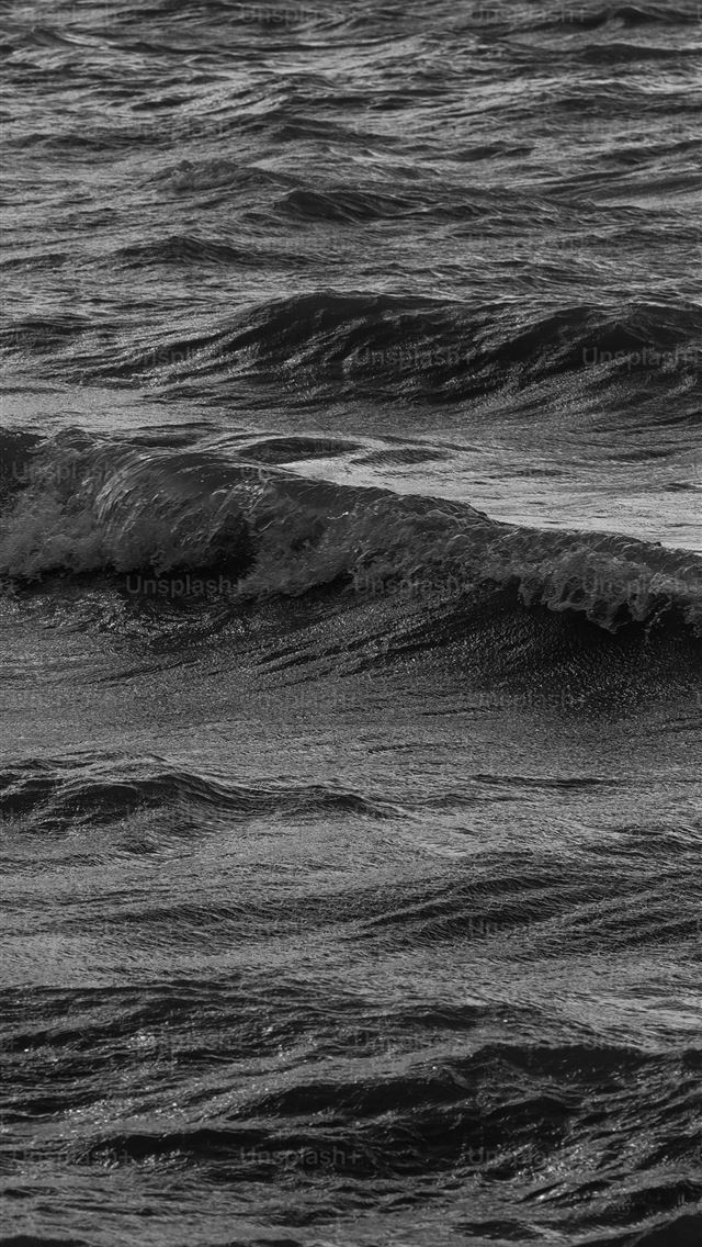640x1136 a man riding a wave on top of a surfboard -  iPhone Wallpaper