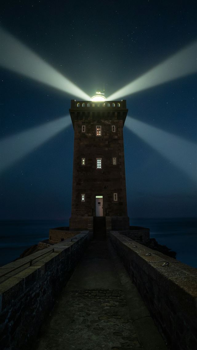 1290x2796 Lighthouse beam sweeps across the starry night sky -  iphone 14 Wallpaper