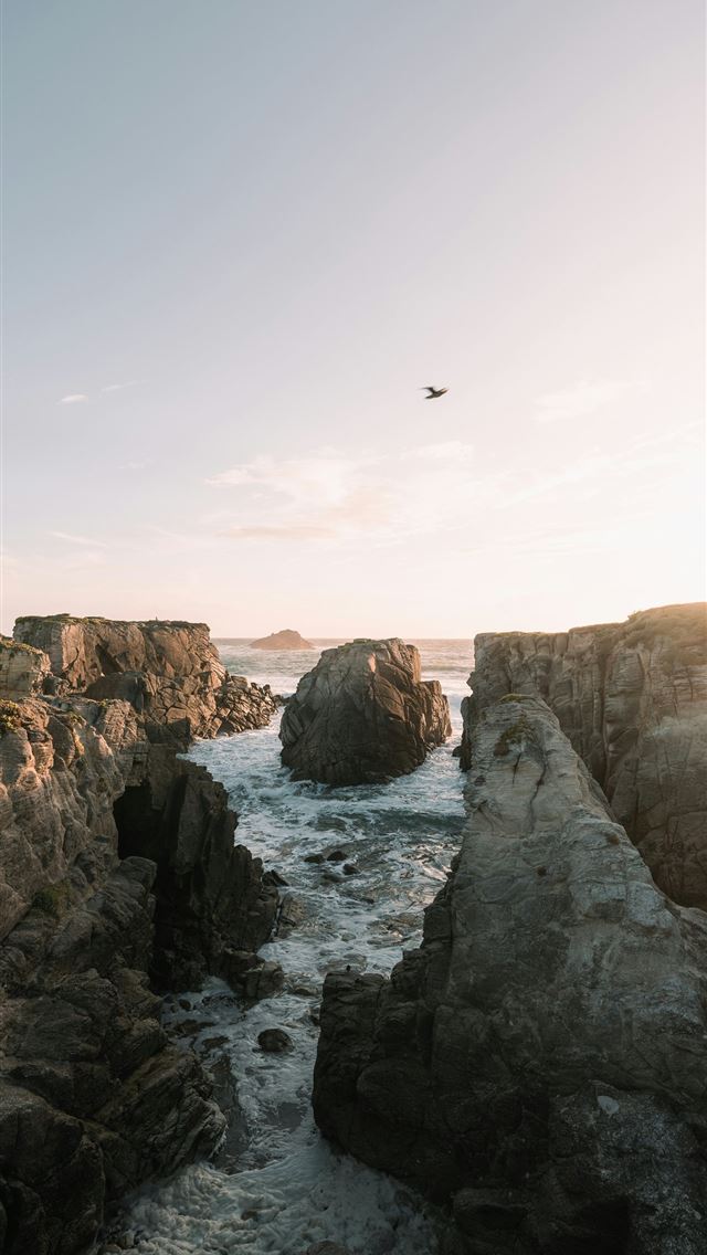 1290x2796 Rocky coastline with waves crashing at sunset  -  iPhone Wallpaper