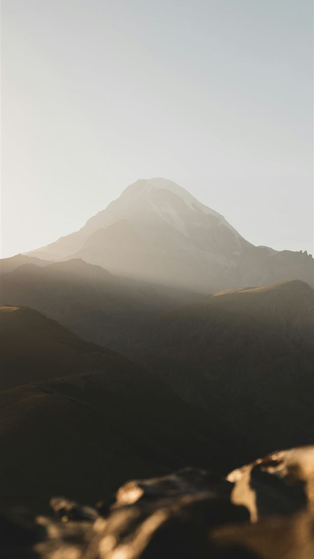 1290x2796 Snow capped mountain peak bathed in soft light -  iPhone Wallpaper