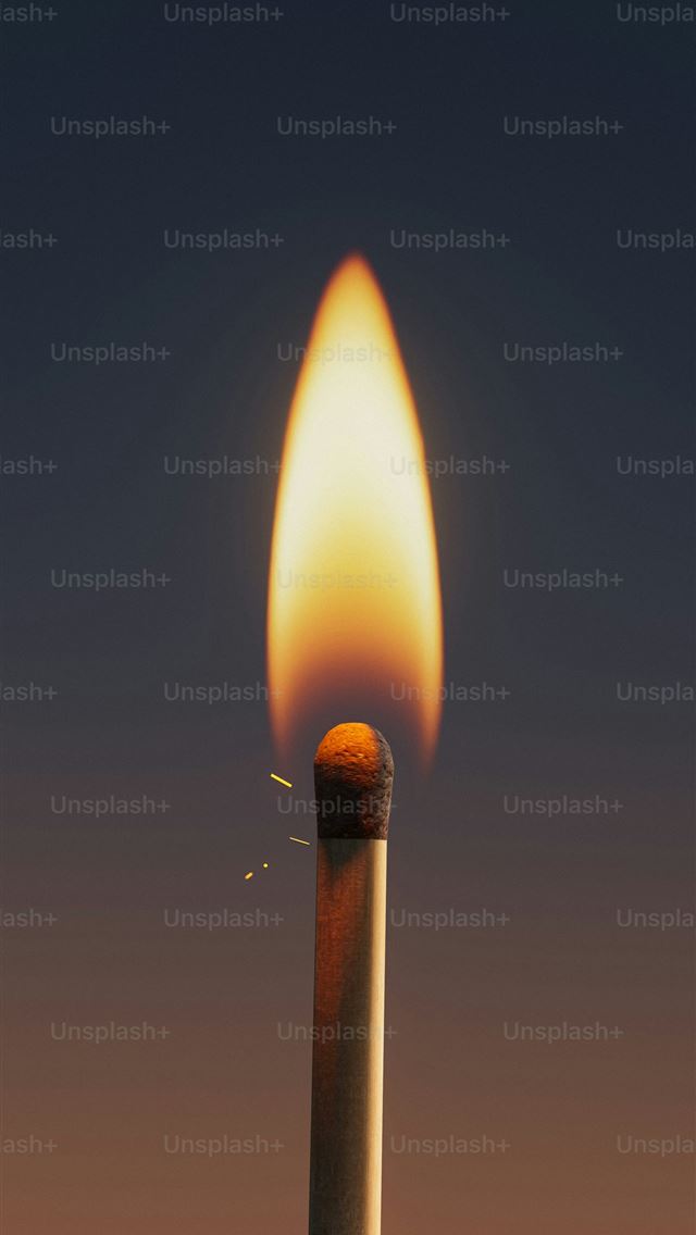 1290x2796 A lit match burns brightly with a flame  -  iPhone Wallpaper