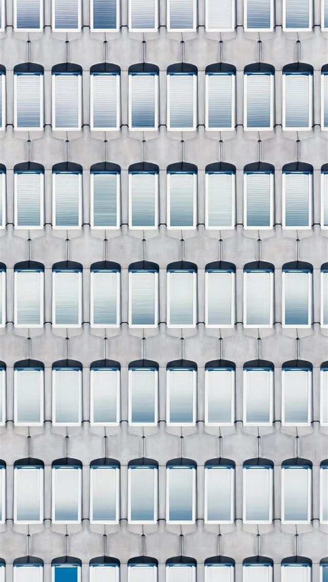 1290x2796 A building with many windows and a blue door -  iPhone Wallpaper