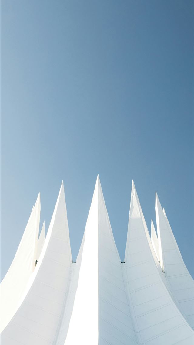 1290x2796 A tall white building with a blue sky in the backg... -  iPhone Wallpaper