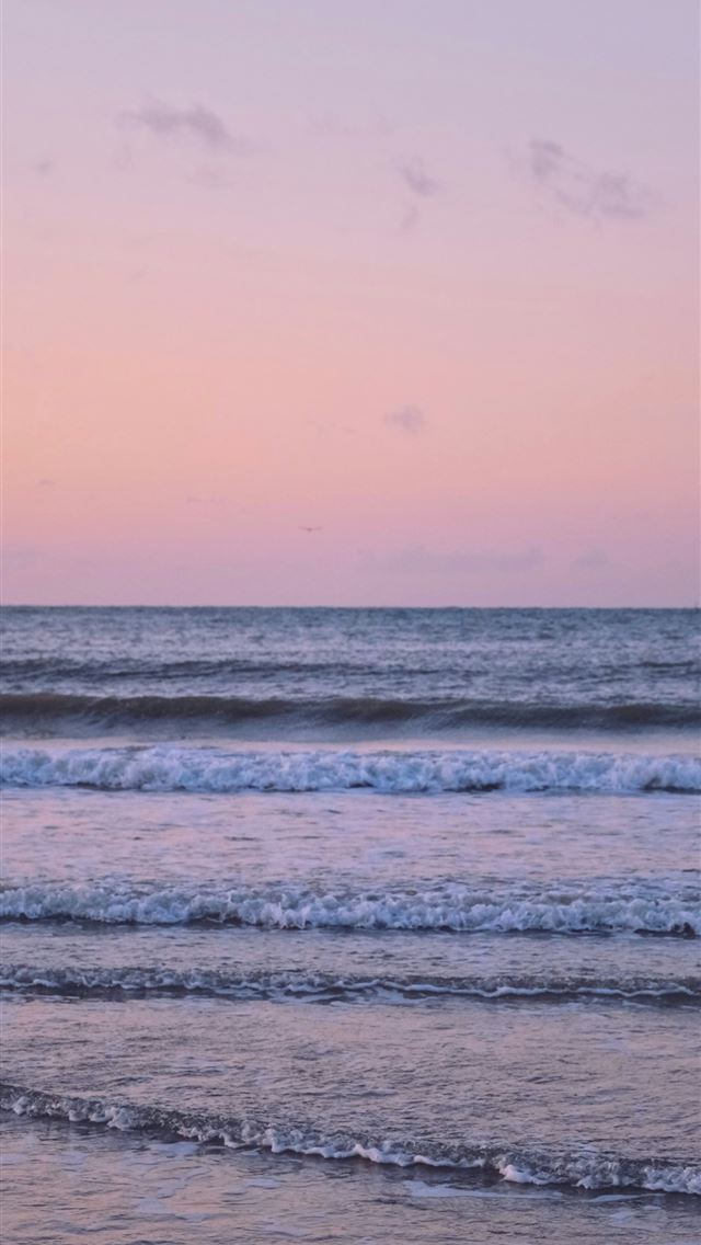1290x2796 Gentle ocean waves under a soft pink sky -  iPhone Wallpaper