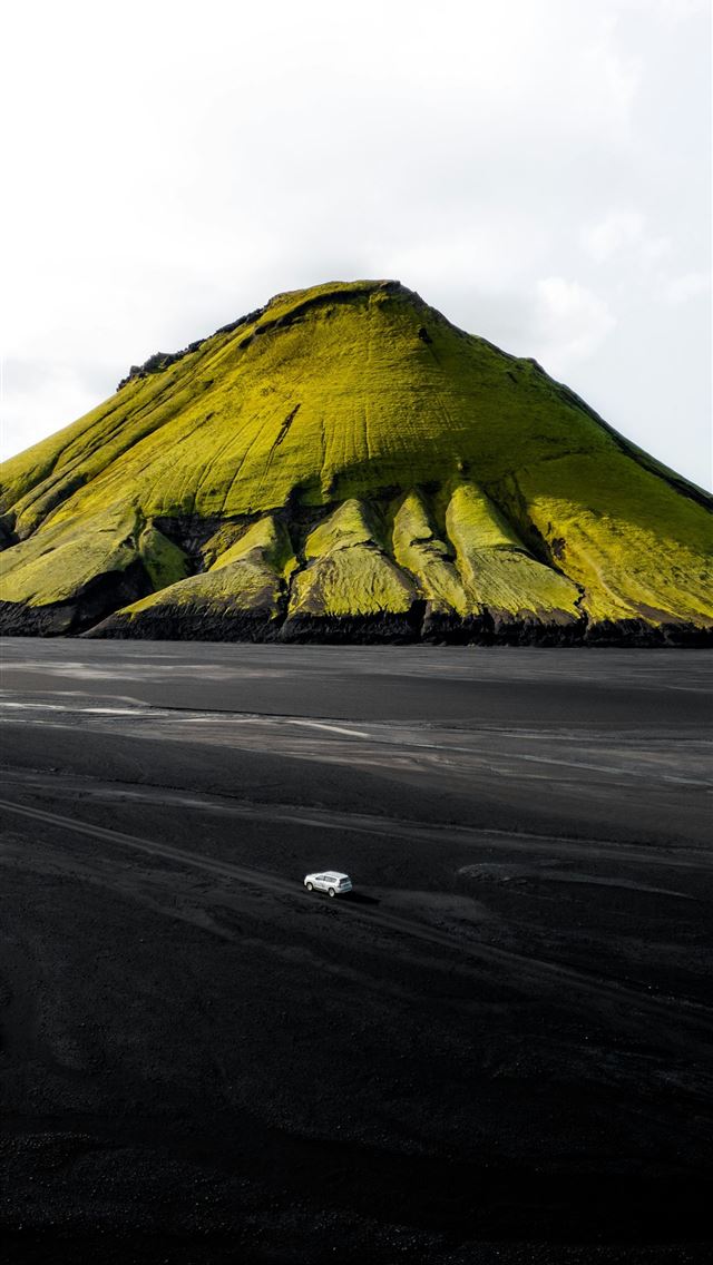 1290x2796 A large hill with a yellow mountain in the backgro... -  iPhone Wallpaper