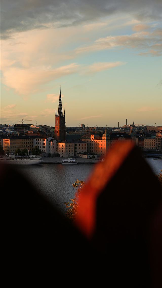 1290x2796 City skyline at sunset with a prominent church spi... -  iPhone Wallpaper