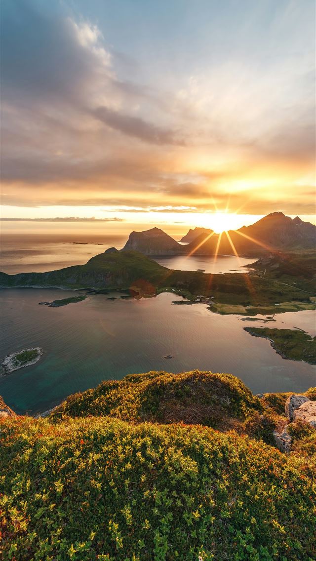 1290x2796 The sun is setting over an island in the ocean -  iPhone Wallpaper