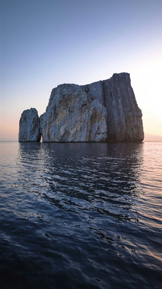 1290x2796 a rock formation in the middle of a body of water -  iPhone Wallpaper