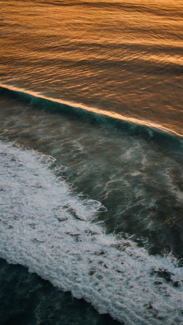 1290x2796 A person riding a surfboard on top of a wave -  iPhone Wallpaper