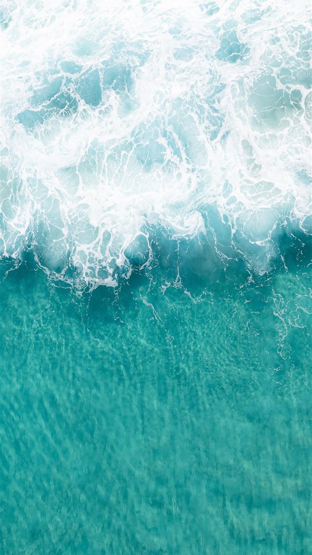1290x2796 A person riding a surfboard on a wave in the ocean -  iPhone Wallpaper