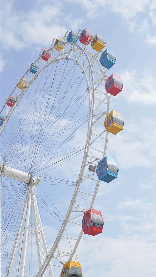 1290x2796 A ferris wheel on a sunny day with a blue sky -  iPhone Wallpaper