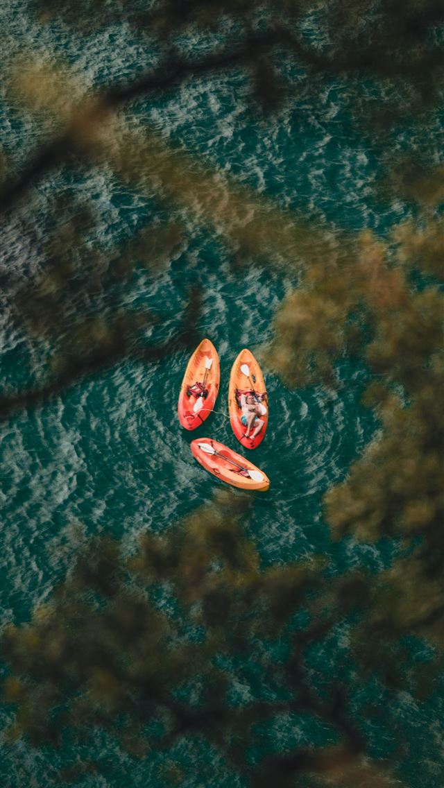 1290x2796 Two people in kayaks floating on a body of water -  iPhone Wallpaper