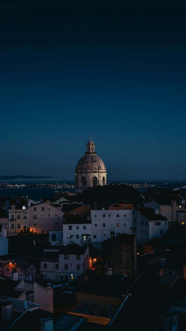 1290x2796 A view of a city at night with the dome of a churc... -  iphone 13 Wallpaper