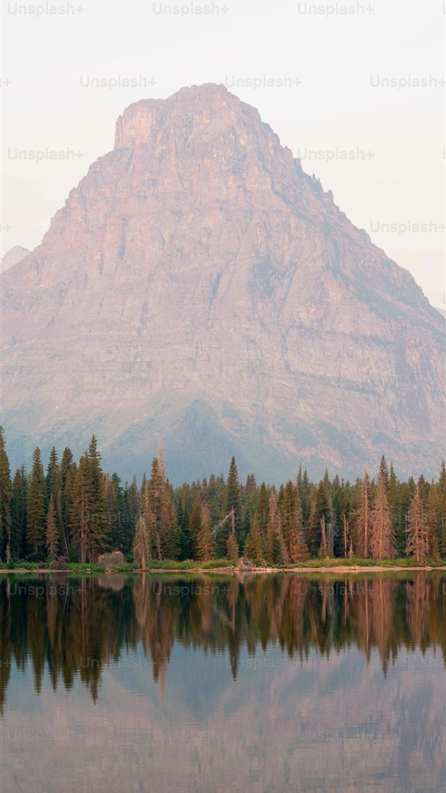 1290x2796 a mountain is reflected in the still water of a la... -  iPhone Wallpaper
