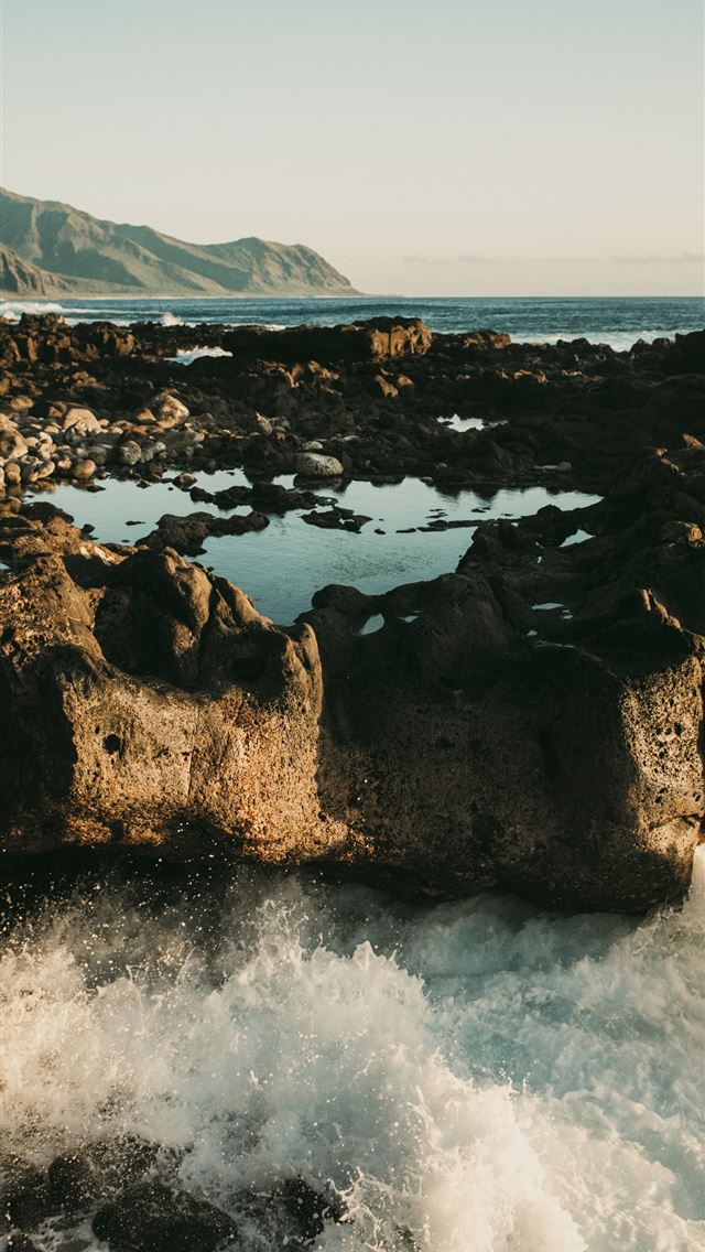 1290x2796 A body of water near a rocky shore -  iPhone Wallpaper