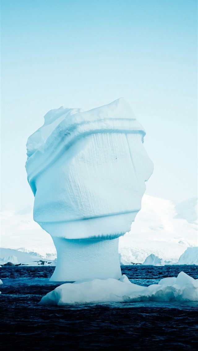 1290x2796 a large iceberg floating on top of a body of water -  iPhone Wallpaper