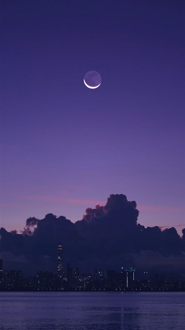 1290x2796 The moon is setting over the city skyline -  iPhone Wallpaper