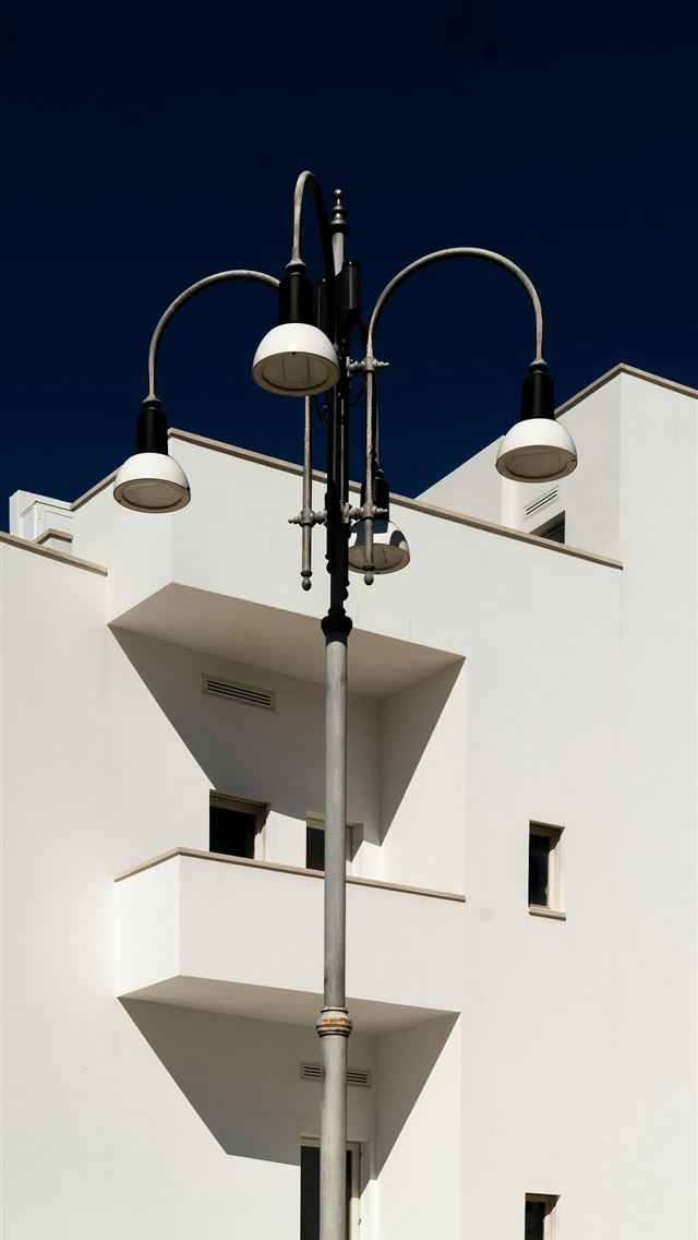 1290x2796 A tall white building with a street light next to ... -  iPhone Wallpaper
