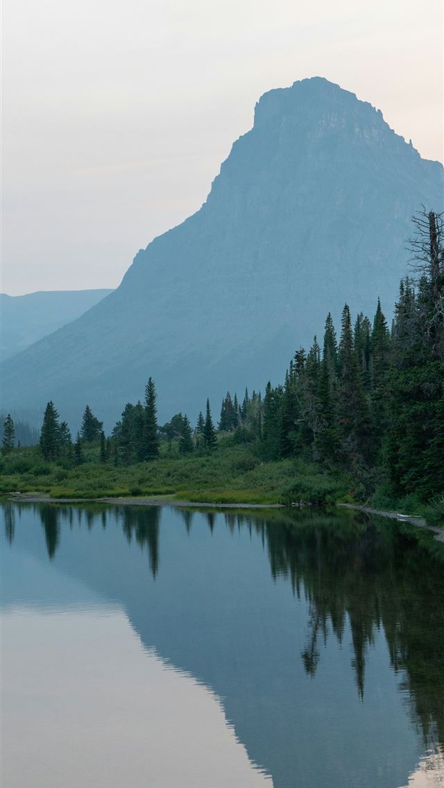 1290x2796 a lake with trees and mountains in the background -  iPhone Wallpaper