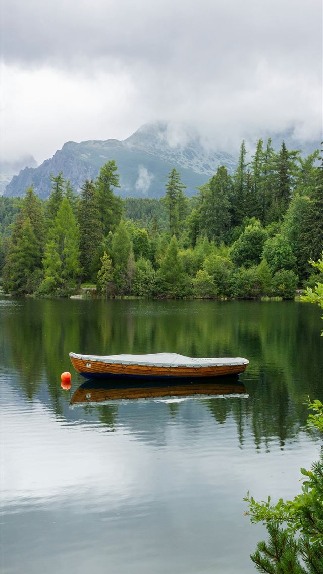 1290x2796 a boat on a lake -  iPhone Wallpaper