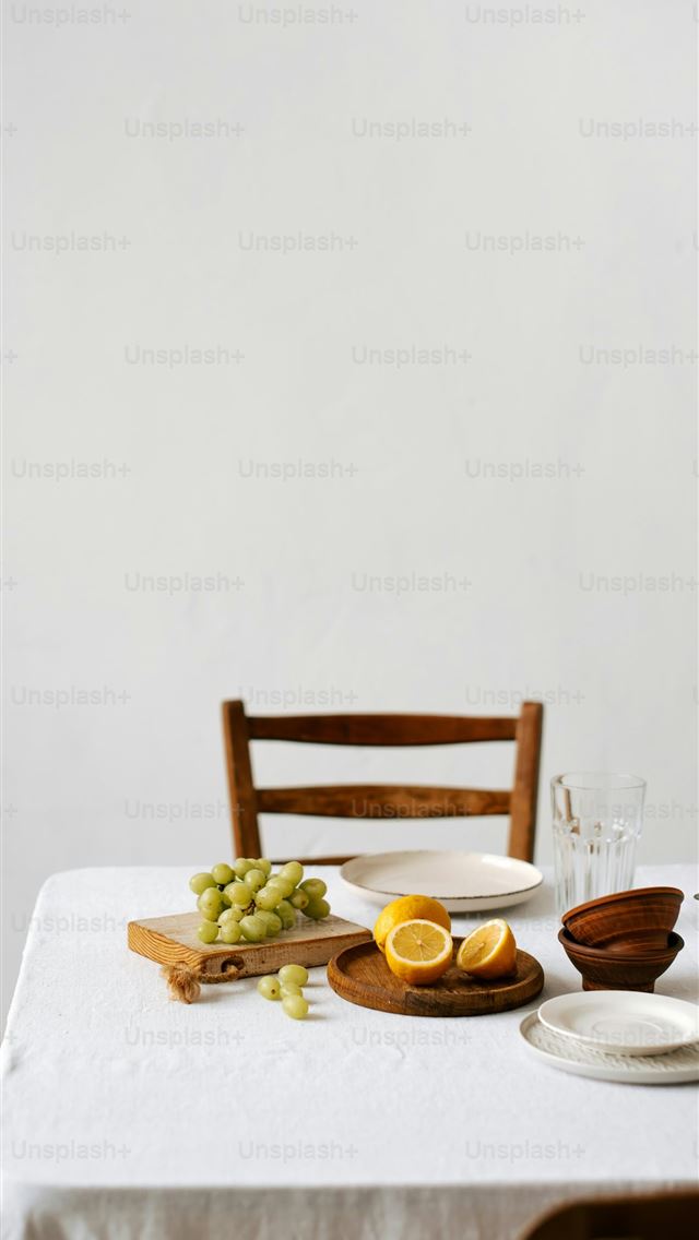 1290x2796 a table with a white table cloth and a wooden chai... -  iPhone Wallpaper