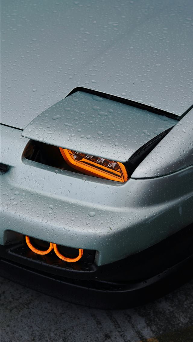 1290x2796 A silver sports car parked in a parking lot -  iPhone Wallpaper