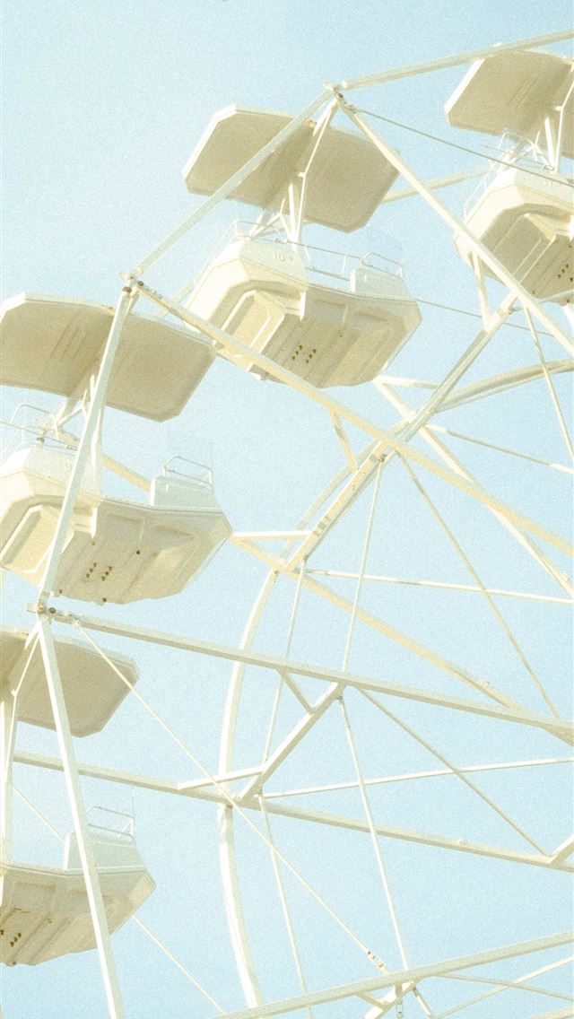 1290x2796 A white ferris wheel against a light blue sky  -  iPhone Wallpaper