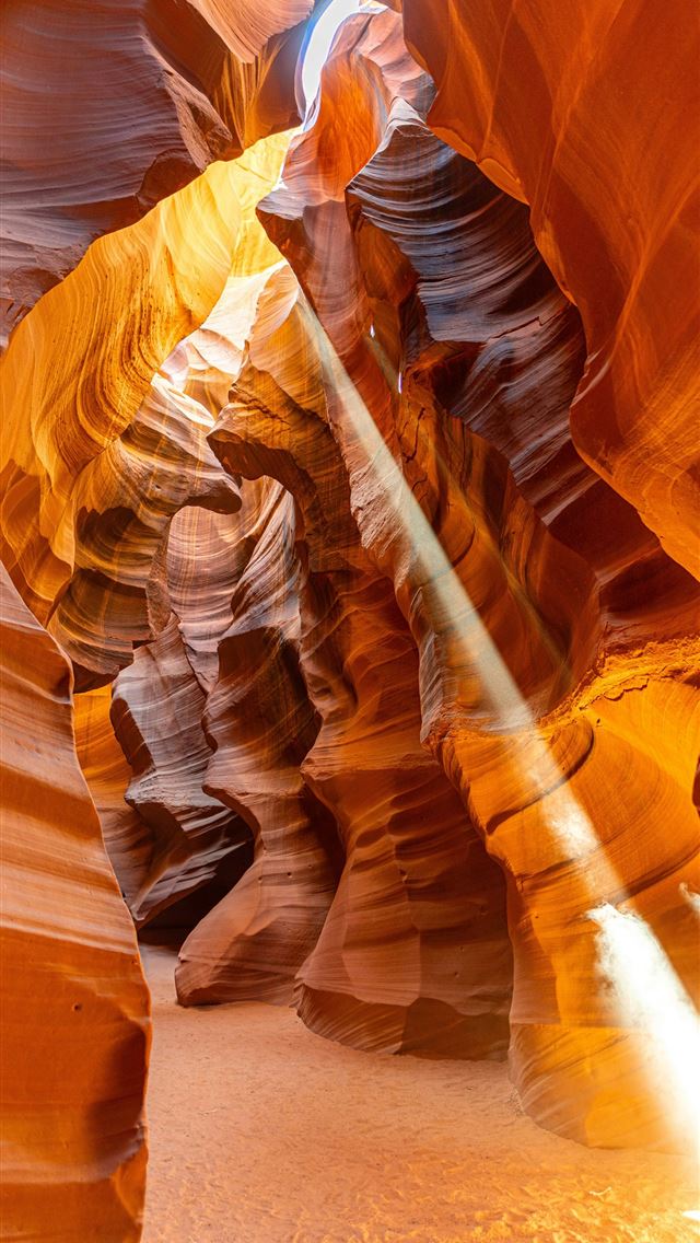 1290x2796 a light shines through a narrow slot in a canyon -  iPhone Wallpaper