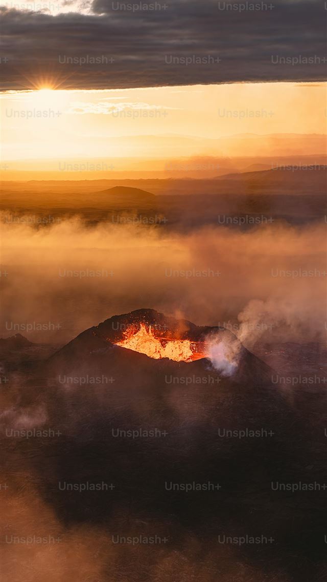 1290x2796 a mountain with a fire in the middle of it -  iPhone Wallpaper