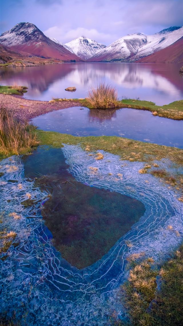 1290x2796 a body of water surrounded by mountains and grass -  iPhone Wallpaper