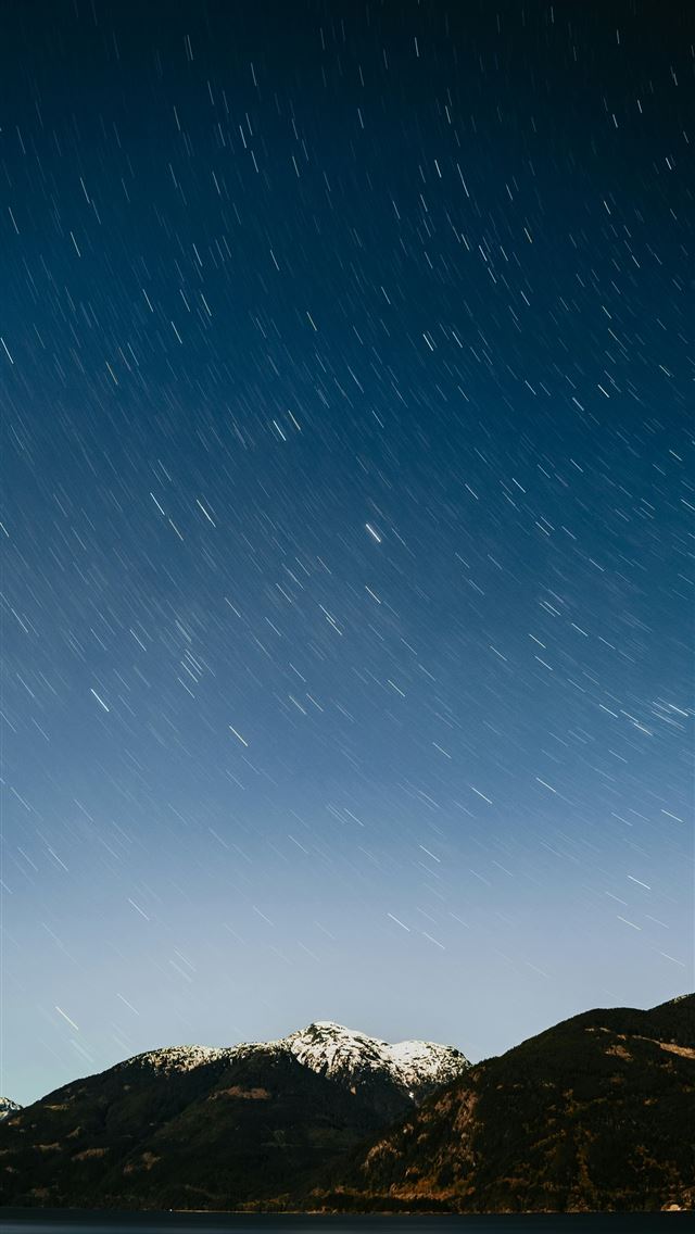 1290x2796 the night sky over a mountain range and a body of ... -  iPhone Wallpaper