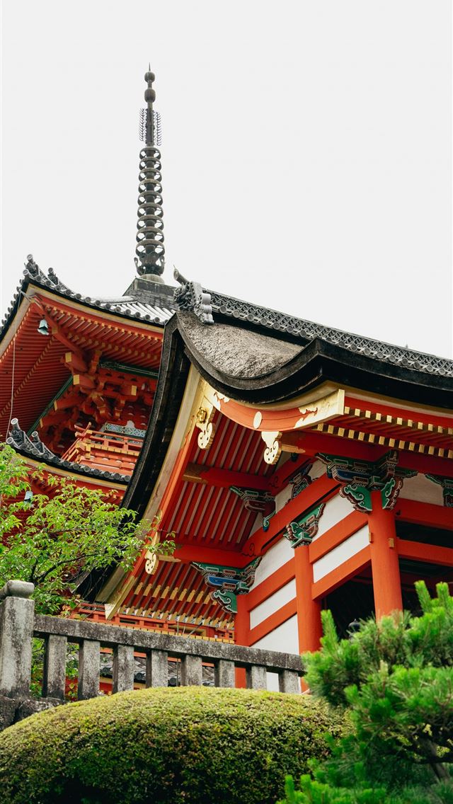 1290x2796 A tall red and white building sitting on top of a ... -  iPhone Wallpaper