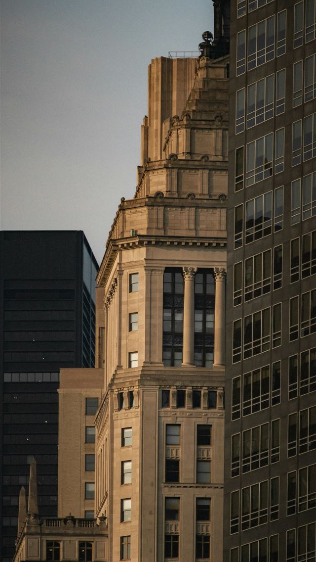 1290x2796 A very tall building in the middle of a city -  iPhone Wallpaper
