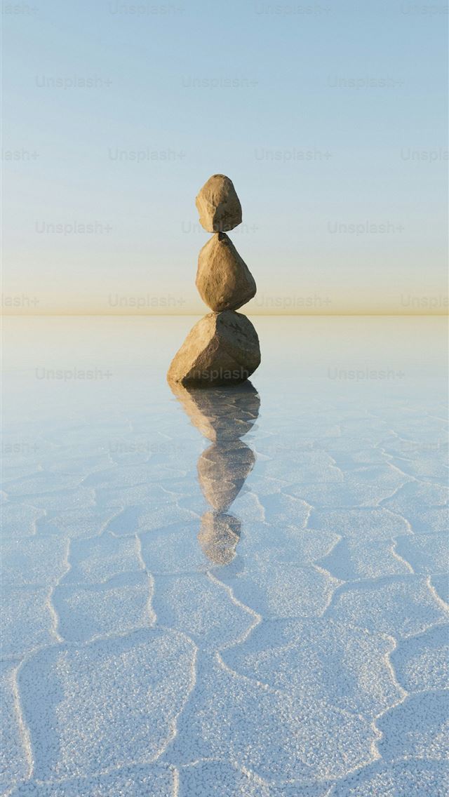 1290x2796 Stacked stones balance on a reflective surface  -  iPhone Wallpaper