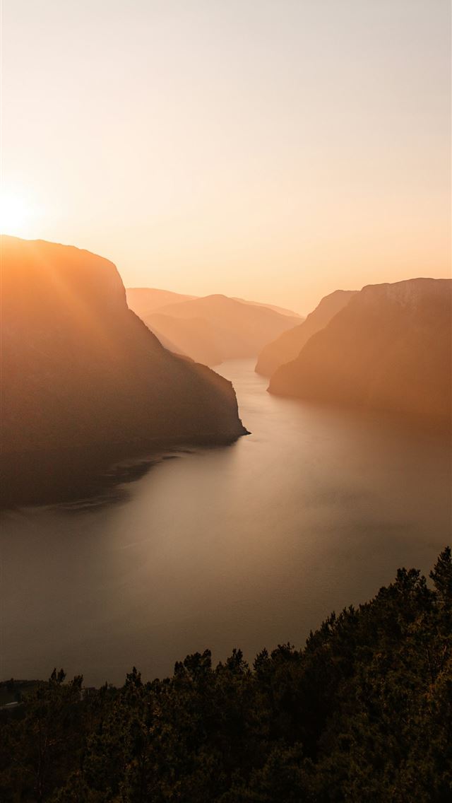 1290x2796 the sun is setting over a lake in the mountains -  iPhone Wallpaper