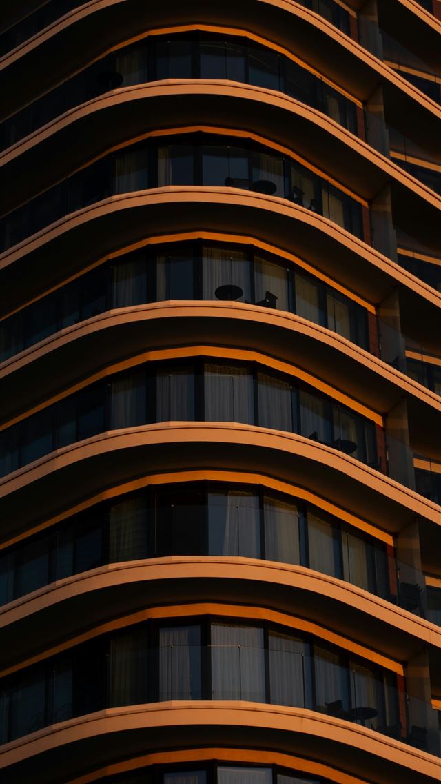 1290x2796 a very tall building with lots of windows -  iPhone Wallpaper