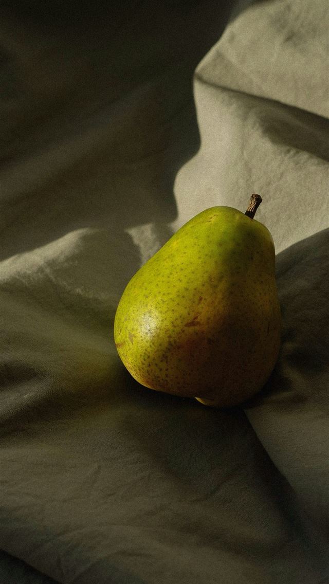 1290x2796 a pear sitting on top of a white sheet -  iPhone Wallpaper