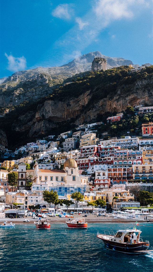 1290x2796 a small boat in a body of water -  iPhone Wallpaper